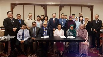 Prof Nirmal Kumar sitting with the Malaysian Ministry of Health