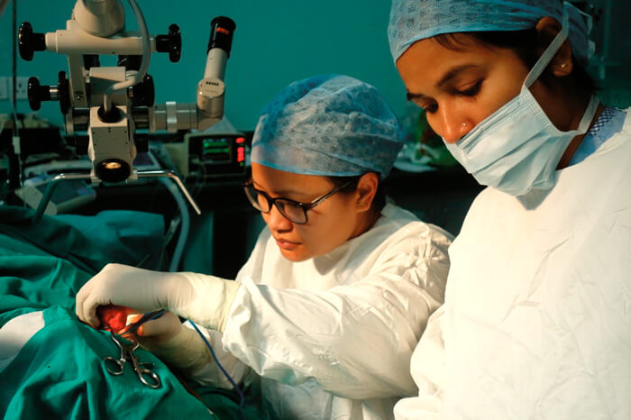 Photo showing Urmila Gurung undertaking ear surgery