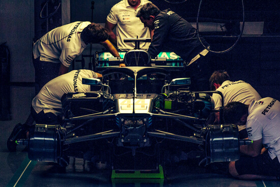 Formula One team photo - mechanics working on racing car