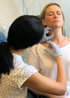 A patient receiving treatment with Botox to reduce facial spasm photo