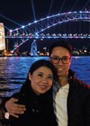 Photo showing Andrew and wife, Annie, with the Sydney Harbour Bridge during the Sydney Vivid light festival.