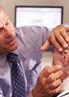 Photo showing ear examination of older patient.