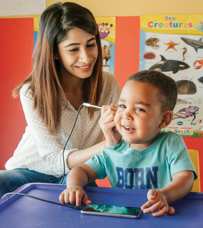 Photo showing hearScreen performed on a child.