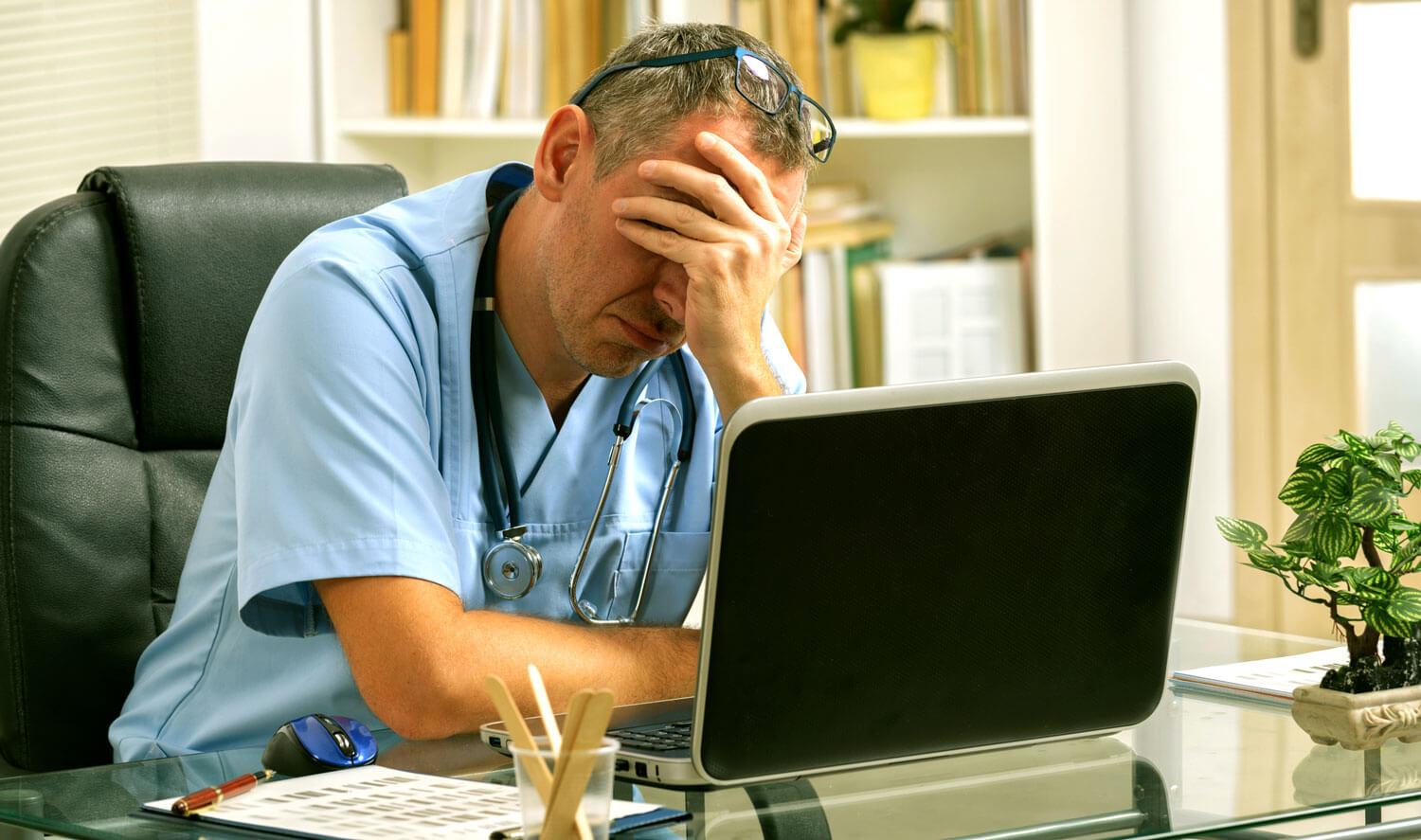 Photo of doctor looking stressed.