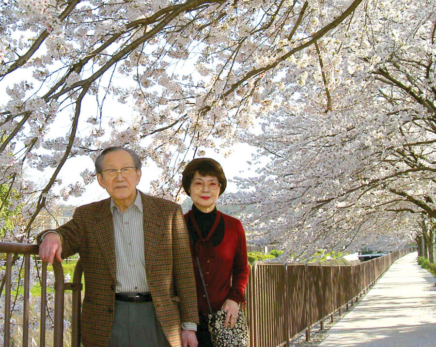 Photo showing Nobuhiko and Keiko and the cherry trees near their house. 
