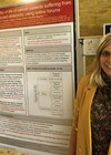 Photo of Stephanie Pearson alongside a poster presentation on the quality of life of cancer patients suffering from chemotherapy induced ototoxicity. 