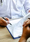 Photo of doctor consulting a form.