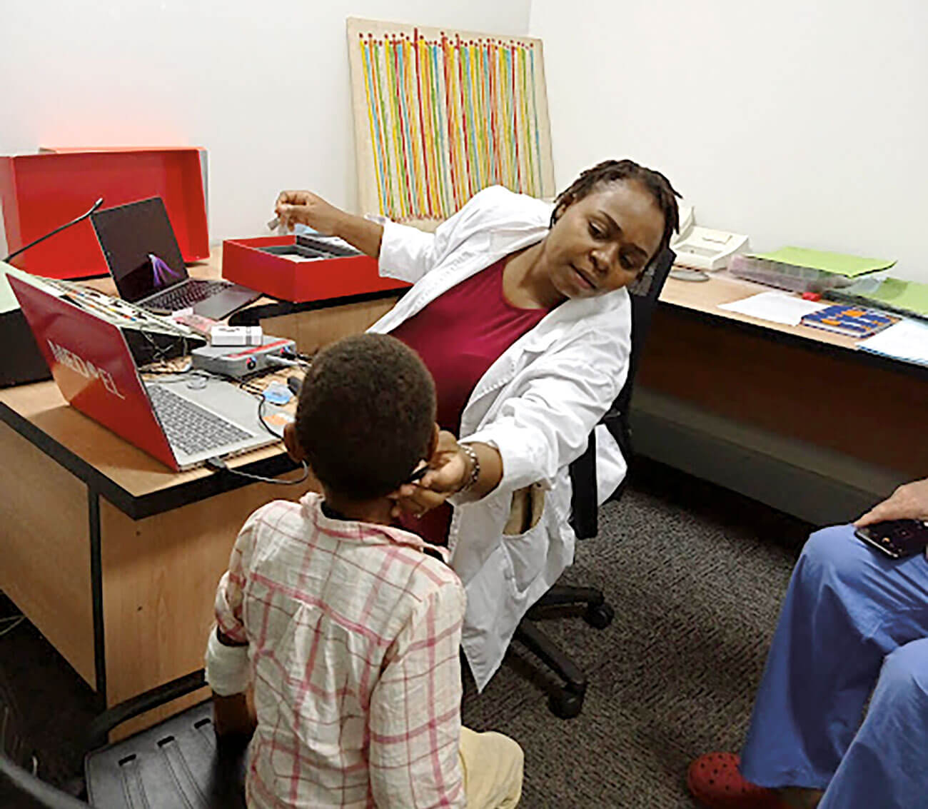 Image showing Chikondi carrying out a patient mapping.