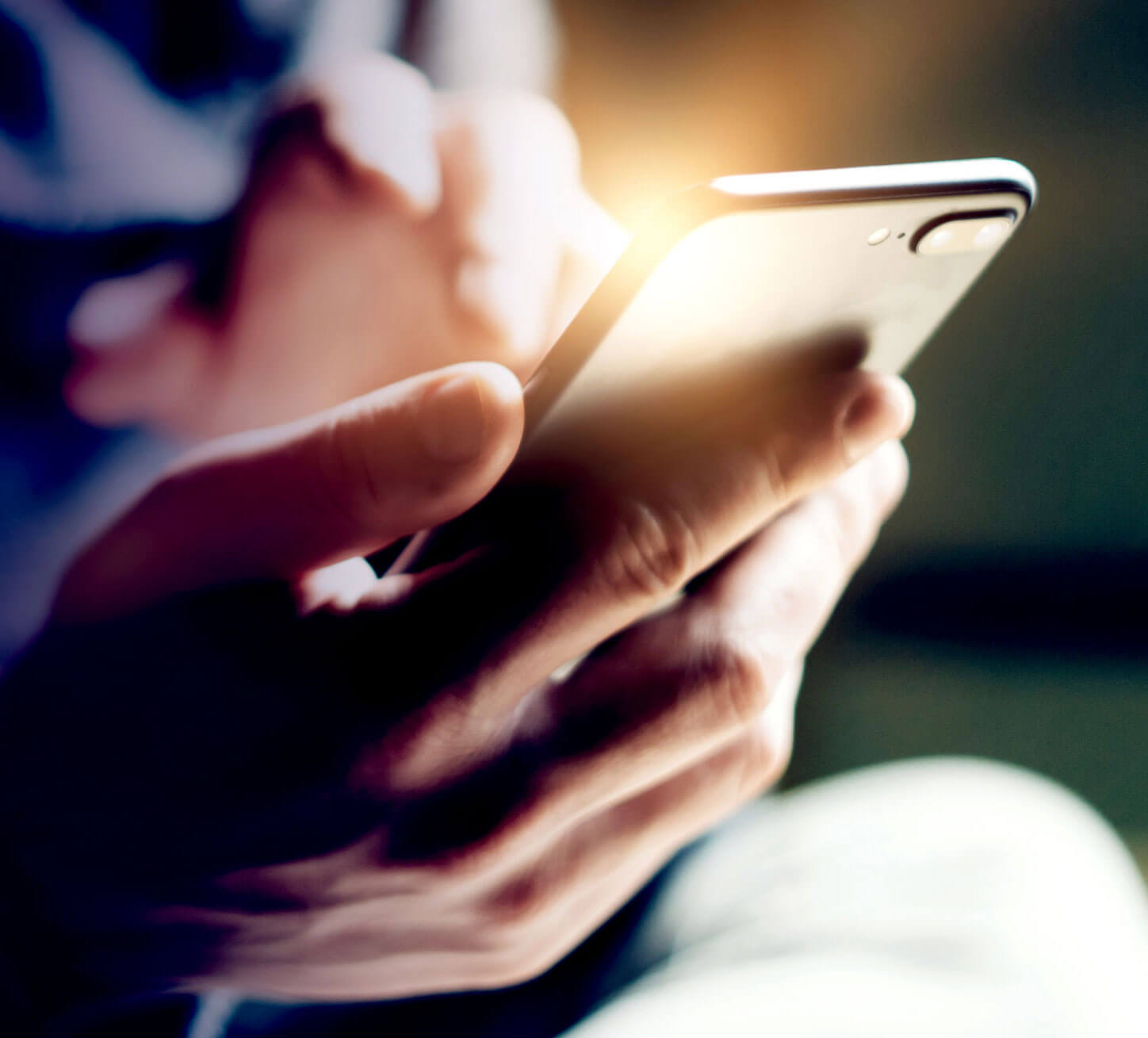 Photo showing person holding mobile phone.