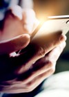 Photo showing person holding mobile phone.
