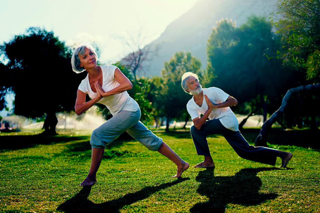Photo of older people exercising in park.