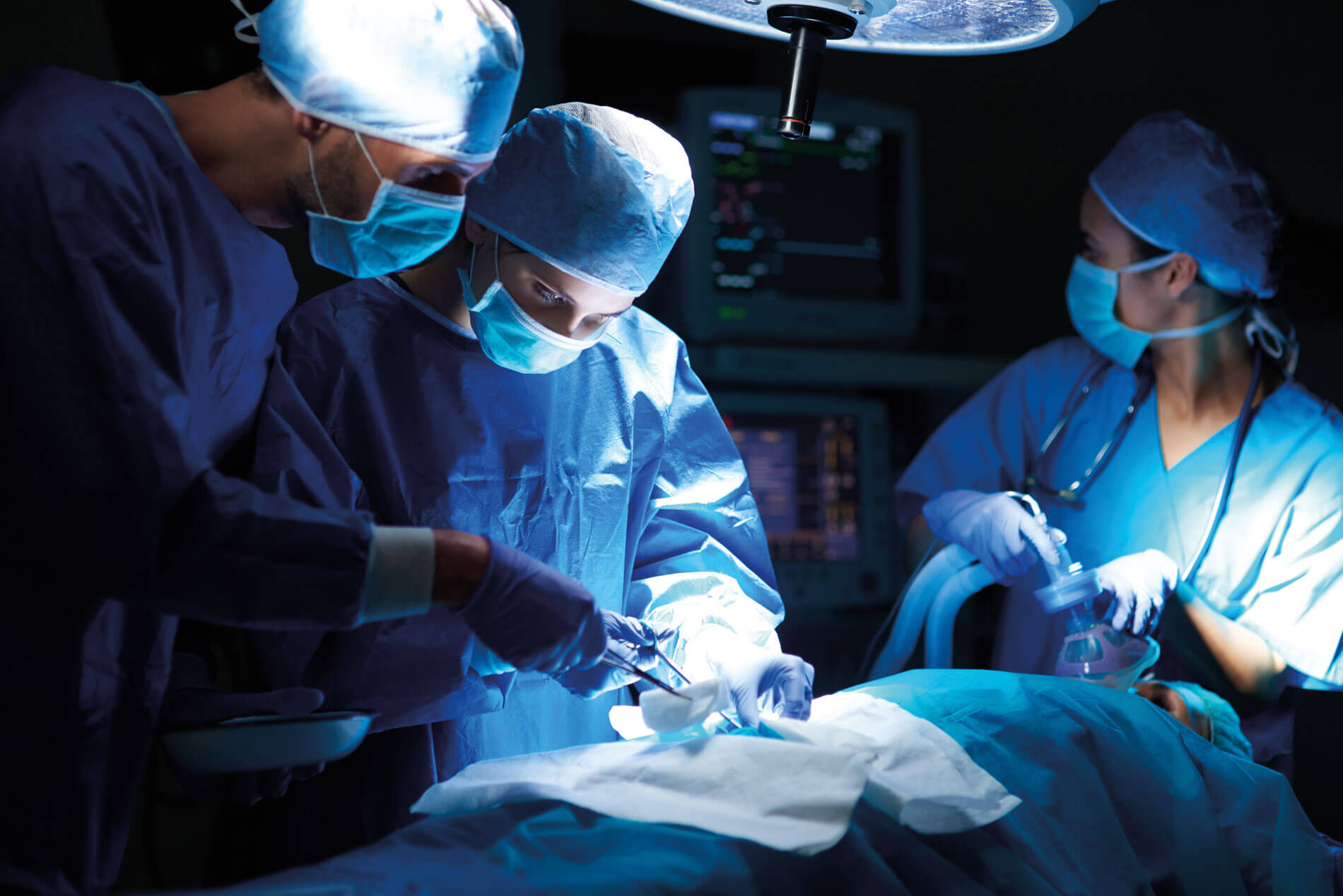 Photo showing surgeons in operating theatre.